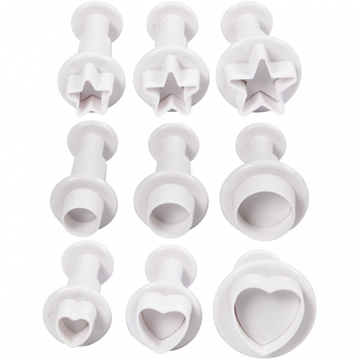 Nio vita utsticksformer i stjärna, cirkel och hjärta i varierande storlekar.